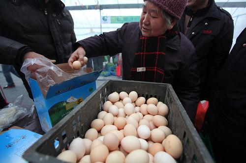 1月22日,市民在農(nóng)產(chǎn)品采購節(jié)現(xiàn)場挑選雞蛋。新華社發(fā)(夏羿 攝)