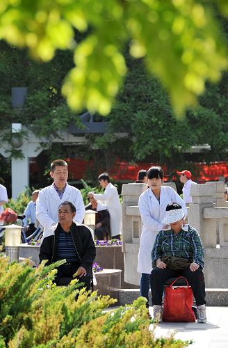 5月19日,在寧夏回族自治區(qū)銀川市街頭,幾位盲人正在給老年人做免費(fèi)按摩。新華社記者 彭昭之 攝