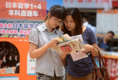 6月24日,學(xué)生和家長在江蘇省2013年普通高校招生咨詢會揚州分會場上了解高校招生相關(guān)信息。新華社發(fā)(孟德龍 攝)