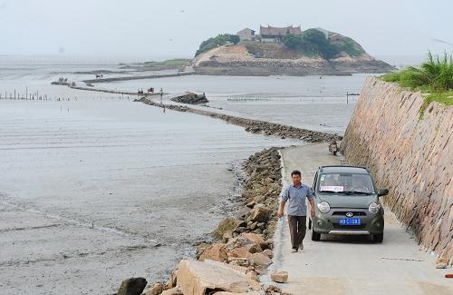 6月26日,一輛小車在600多米長的草嶼島跨海路上行駛。新華社記者 林善傳 攝