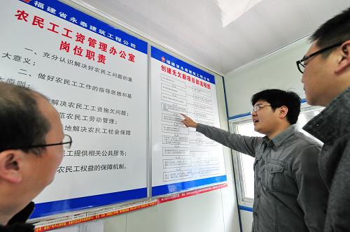 1月3日,福建省永泰建筑工程有限公司“東泰華府”建筑工地?zé)o欠薪項(xiàng)目部辦公室工作人員(中)在向霞浦縣人社局工作人員介紹該公司創(chuàng)建無欠薪流程建設(shè)情況。新華社記者 林善傳 攝