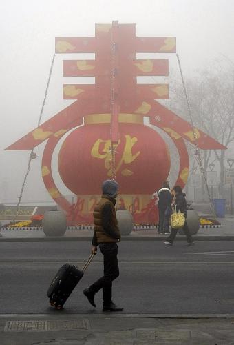 1月30日,行人走在大霧籠罩的蘇州街頭。新華社發(fā)(王建康 攝)