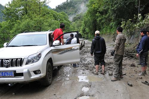 7月14日,受阻車輛在川藏公路波密縣境內(nèi)發(fā)生泥石流的路段等候通行。新華社發(fā)(汪巍 攝)