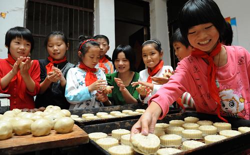 9月7日,六安市裕安區(qū)固鎮(zhèn)鎮(zhèn)中心小學的留守兒童在學做月餅。新華社發(fā)(陳力 攝)