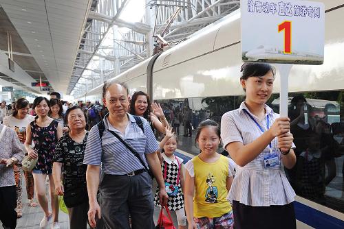 8月9日,乘坐首趟旅游動(dòng)車專列的旅客在重慶北站工作人員的引導(dǎo)下乘車。當(dāng)日,西南地區(qū)首趟旅游動(dòng)車專列——重慶至都江堰動(dòng)車開通運(yùn)行。按照計(jì)劃,重慶至都江堰目前每周周末試開行兩對(duì)旅游直達(dá)動(dòng)車,并將進(jìn)一步調(diào)整為常態(tài)化運(yùn)行。動(dòng)車專列開通后,重慶至都江堰交通時(shí)間將由6小時(shí)縮短至3小時(shí)左右。新華社記者 李健 攝
