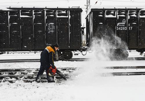 11月21日,一名鐵路工人在軌道旁用吹雪機(jī)吹去積雪。來自烏魯木齊氣象臺的消息:11月20日23時左右,烏魯木齊開始出現(xiàn)降雪,目前已連續(xù)降雪十幾個小時,降雪量為13.4毫米,已達(dá)到暴雪級別。連夜的大雪掩埋了鐵路,烏魯木齊鐵路局組織職工加緊鐵軌清雪工作,確保列車正常運(yùn)行。新華社記者 王菲 攝