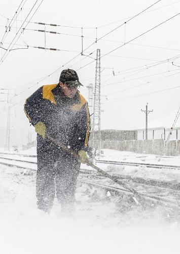 11月21日,鐵路工人在軌道旁清掃積雪。新華社記者 王菲 攝