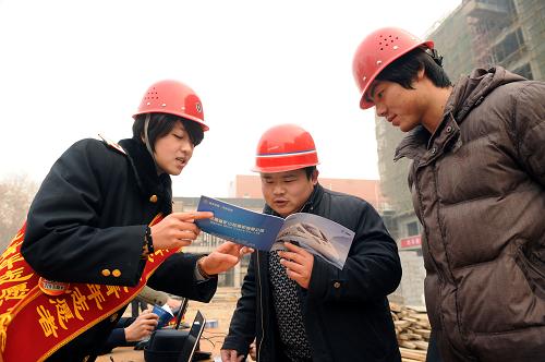 1月14日,鄭州鐵路局新鄉(xiāng)車務(wù)段的工作人員(左)在為外來務(wù)工人員介紹春運期間的車次。新華社記者 李博 攝