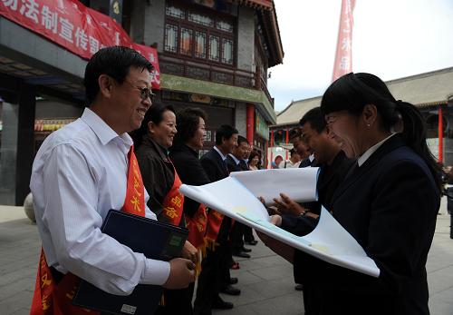5月24日,呼和浩特市藝術(shù)品經(jīng)營商戶代表(右)領(lǐng)取國家關(guān)于藝術(shù)品市場的法規(guī)資料。新華社記者 張領(lǐng) 攝