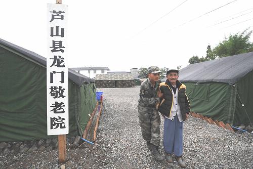一名戰(zhàn)士攙扶行動不便的老人(5月16日攝)。新華社記者 李曉果 攝