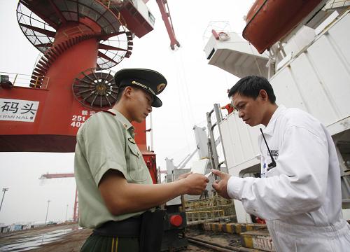 太倉邊防檢查站二中隊的戰(zhàn)士在太倉港散貨碼頭檢查一艘巴拿馬籍貨輪人員的出入境證件和手續(xù)(6月1日攝)。 今年以來,江蘇太倉邊防檢查站圍繞“大港口、大物流、大產業(yè)”的發(fā)展戰(zhàn)略,創(chuàng)新邊檢服務管理,將辦證大廳前移至碼頭企業(yè),通過設立“網上邊檢”,開通“7×24小時”服務熱線、邊檢QQ群、微信、短信告知等特色服務,為太倉口岸營造“和諧、安全、高效、暢通”的通關環(huán)境。據最新數據統(tǒng)計,今年1至5月,太倉邊防檢查站共檢查出入境人員23125人次,出入境船舶1253艘次,同比增長22.6%和23.6%。 新華社記者 王申 攝
