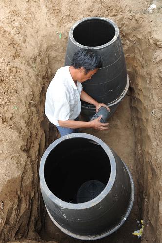 6月14日,在河北省內(nèi)丘縣金店鎮(zhèn)大辛旺村,村民正在安裝“雙甕漏斗式廁所”。 自2011年以來,河北省內(nèi)丘縣在全縣平原區(qū)5個鄉(xiāng)鎮(zhèn)、3.6萬戶農(nóng)戶中推廣“雙甕漏斗式廁所”。這種廁所由漏斗形蹲便器、前后兩個甕式儲糞池、連通管、后寬蓋和廁室組成。“雙甕”一前一后埋入地下,前甕連著蹲便器口,后甕用蓋密封,前高后低,中間相互連通。甕儲滿后掀開密封蓋,抽出來的發(fā)酵糞便還可做肥料。 “雙甕漏斗式廁所”不僅占地面積小,還方便衛(wèi)生,一改傳統(tǒng)旱廁“晴天臭烘烘,雨天糞水流”的臟亂差面貌。目前,內(nèi)丘縣已經(jīng)完成改建“雙甕漏斗式”廁所近萬個。 新華社記者王民攝