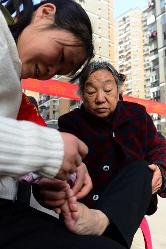 3月5日,志愿者在為74歲的尹葉嬌老人(右)修腳。新華社記者 程敏 攝
