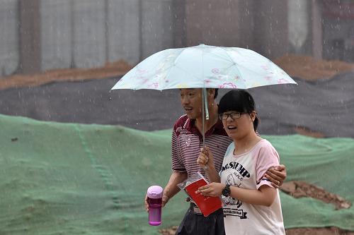 父母心 6月7日,在山西太原第二十七中高考考點外,一位家長冒雨送考生。 當日,2013年高考拉開帷幕??紙鐾?,隨處可見眾多陪考的考生家長。 新華社發(fā)(胡遠嘉 攝)