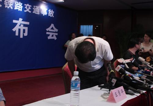 7月24日,鐵道部新聞發(fā)言人王勇平向事故發(fā)生時被困在列車上的一位記者鞠躬致歉。新華社記者 邢廣利 攝