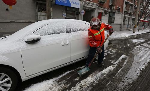 2月7日,北京市西城區(qū)環(huán)衛(wèi)工人在街頭清理積雪。 新華社記者 張玉薇 攝