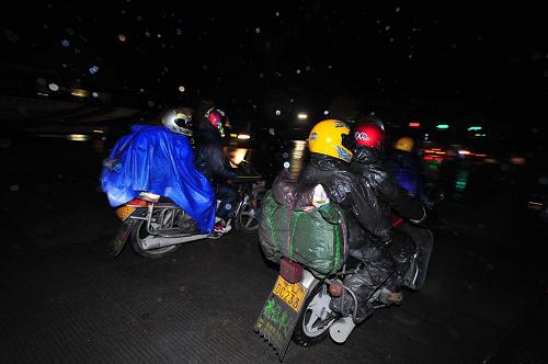 2011年1月19日,在210國道廣西南丹縣境內(nèi),一群騎手在雨中趕路。 棉衣、護(hù)膝、雨衣、棉毯、手套……當(dāng)日,一群“全副武裝”騎摩托車冒雨返鄉(xiāng)的農(nóng)民工行至210國道廣西南丹縣境內(nèi)。這批由數(shù)十人組成的摩托車返鄉(xiāng)隊(duì)伍,1月17日從廣東出發(fā),準(zhǔn)備驅(qū)車近2000公里回貴州老家過年。 新華社記者 黃孝邦 攝
