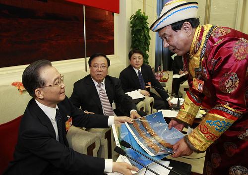 3月6日,中共中央政治局常委、國(guó)務(wù)院總理溫家寶參加他所在的十一屆全國(guó)人大三次會(huì)議甘肅代表團(tuán)的審議。這是全國(guó)人大代表安國(guó)鋒(裕固族)向溫家寶總理介紹黑河流域濕地保護(hù)情況。 新華社記者 李學(xué)仁 攝