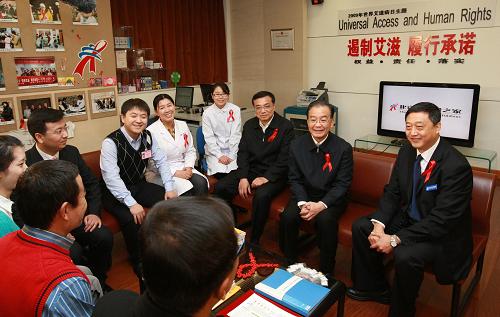12月1日,中共中央政治局常委、國務(wù)院總理溫家寶和中共中央政治局常委、國務(wù)院副總理李克強(qiáng)來到位于北京地壇醫(yī)院的北京紅絲帶之家,看望這里的艾滋病感染者、醫(yī)護(hù)人員和志愿者,并主持召開座談會,聽取專家對艾滋病防治工作的意見和建議。這是溫家寶、李克強(qiáng)在位于地壇醫(yī)院的北京紅絲帶之家與艾滋病患者(兩位、背影)、志愿者及醫(yī)護(hù)人員交談。 新華社記者 龐興雷 攝