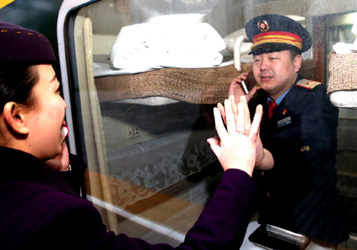 2月3日，鐵路上?？瓦\(yùn)段列車(chē)員黃斌、顧蓉夫婦在發(fā)車(chē)前隔窗相互道別。新華社記者 陳飛 攝